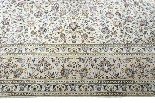 Corner detail of 2000s Kashan rug showing border pattern and Wool pile