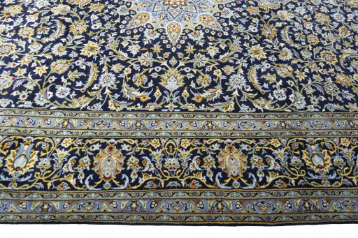 Corner detail of 2000s Kashan rug showing border pattern and Wool pile