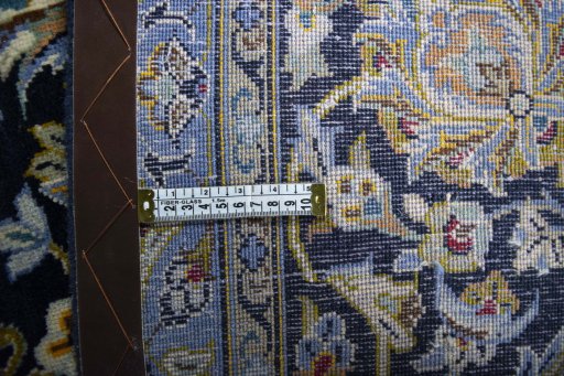 Backside of handmade 2000s Kashan rug showing knot structure and weave density