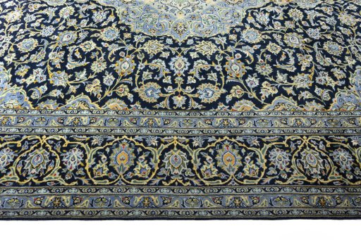 Corner detail of 2000s Kashan rug showing border pattern and Wool pile