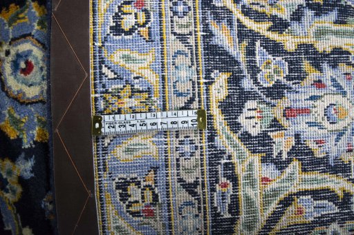 Backside of handmade 2000s Kashan rug showing knot structure and weave density