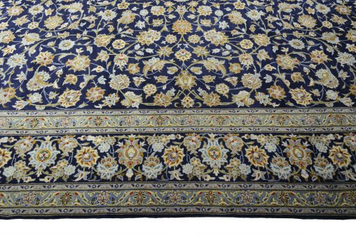 Corner detail of 2000s Kashan rug showing border pattern and Wool pile