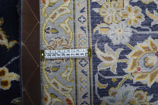Backside of handmade 2000s Kashan rug showing knot structure and weave density