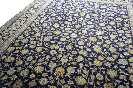 Backside of handmade 2000s Kashan rug showing knot structure and weave density