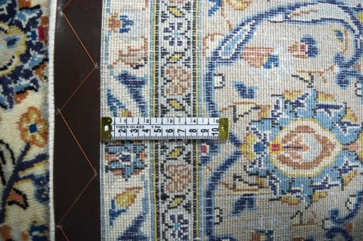 Backside of handmade 2000s Kashan rug showing knot structure and weave density