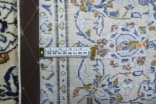Backside of handmade New Kashan rug showing knot structure and weave density