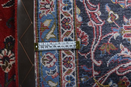 Backside of handmade 2000s Kashan rug showing knot structure and weave density