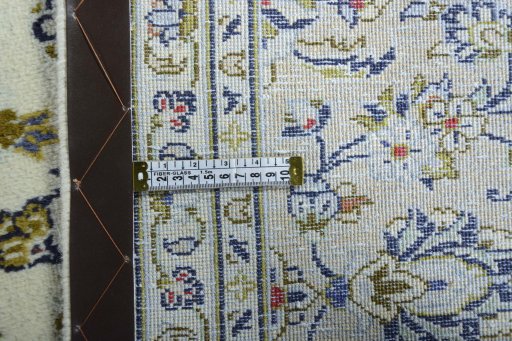 Backside of handmade New Kashan rug showing knot structure and weave density