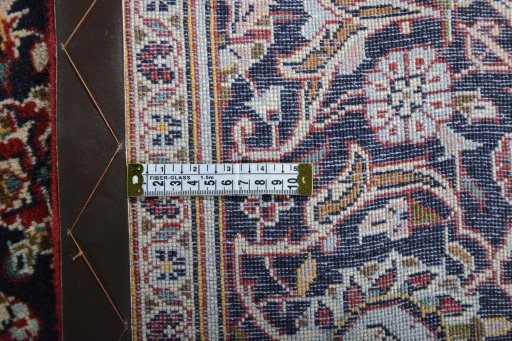Backside of handmade 2000s Kashan rug showing knot structure and weave density