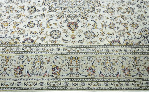 Corner detail of 2000s Kashan rug showing border pattern and Wool pile