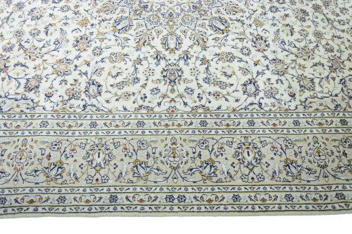 Corner detail of 2000s Kashan rug showing border pattern and Wool pile