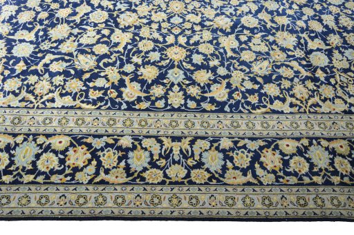 Corner detail of 2000s Kashan rug showing border pattern and Wool pile