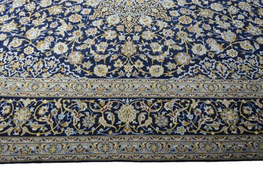 Corner detail of 2000s Kashan rug showing border pattern and Wool pile