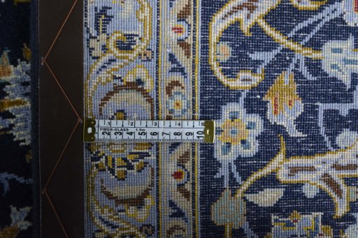 Backside of handmade 2000s Kashan rug showing knot structure and weave density
