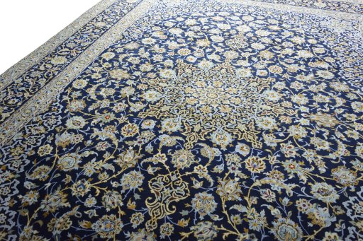 Backside of handmade 2000s Kashan rug showing knot structure and weave density