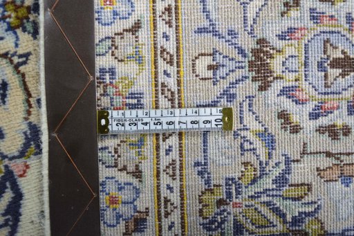 Backside of handmade 2000s Kashan rug showing knot structure and weave density