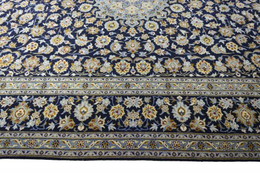 Corner detail of 2000s Kashan rug showing border pattern and Wool pile