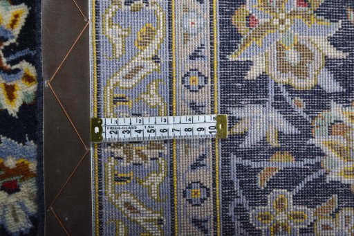 Backside of handmade 2000s Kashan rug showing knot structure and weave density