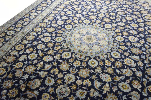 Backside of handmade 2000s Kashan rug showing knot structure and weave density