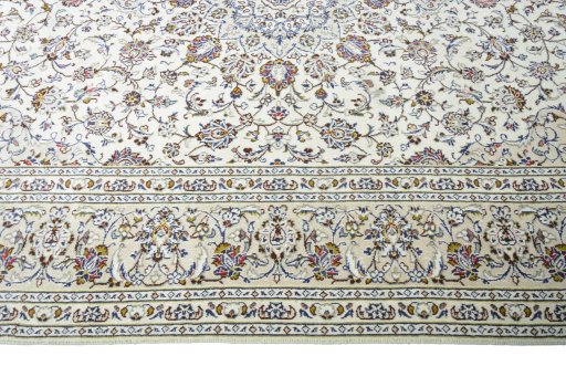 Corner detail of 2000s Kashan rug showing border pattern and Wool pile