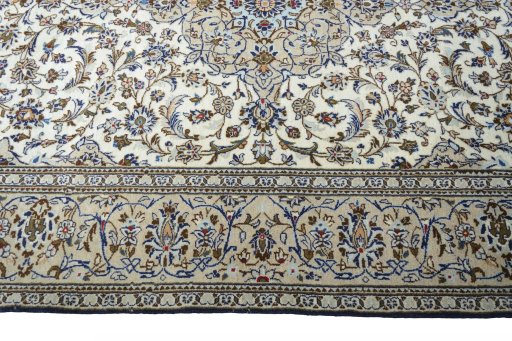 Corner detail of 2000s Kashan rug showing border pattern and Wool pile