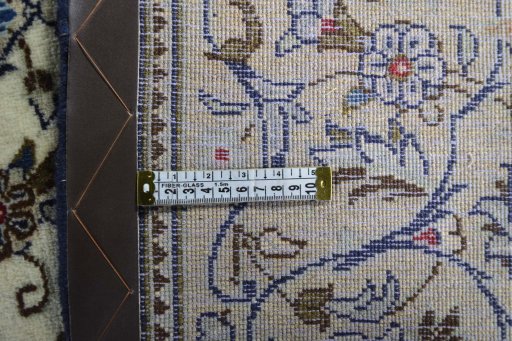 Backside of handmade 2000s Kashan rug showing knot structure and weave density