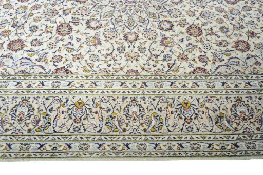 Corner detail of 2000s Kashan rug showing border pattern and Wool pile