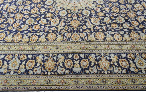 Corner detail of 2000s Kashan rug showing border pattern and Wool pile