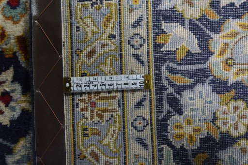 Backside of handmade 2000s Kashan rug showing knot structure and weave density