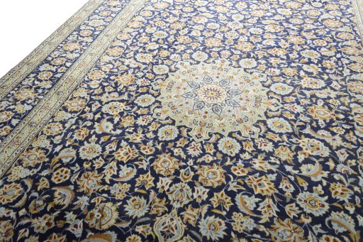 Backside of handmade 2000s Kashan rug showing knot structure and weave density