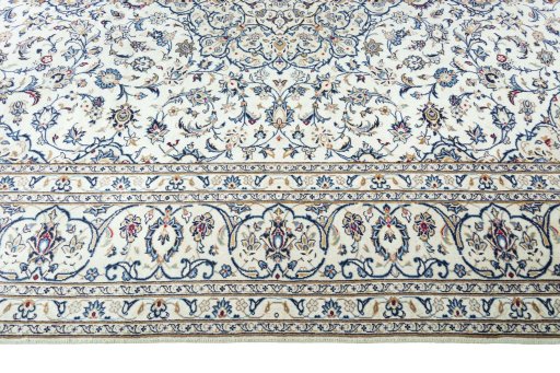 Corner detail of 2000s Kashan rug showing border pattern and Wool pile
