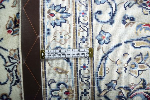 Backside of handmade 2000s Kashan rug showing knot structure and weave density
