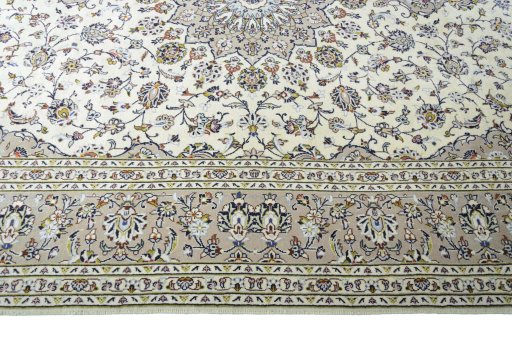 Corner detail of 2000s Kashan rug showing border pattern and Wool pile