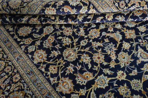 Close-up detail of 2000s Kashan rug from Iran / Persia showing Wool weave