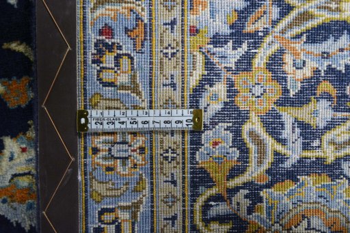 Backside of handmade 2000s Kashan rug showing knot structure and weave density