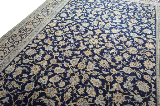 Backside of handmade 2000s Kashan rug showing knot structure and weave density