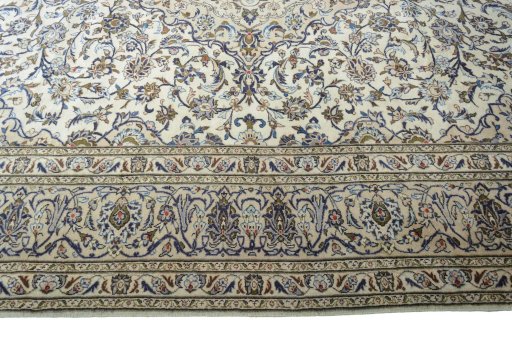 Corner detail of 2000s Kashan rug showing border pattern and Wool pile