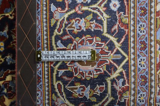 Backside of handmade 2000s Kashan rug showing knot structure and weave density