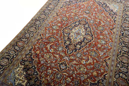 Backside of handmade 2000s Kashan rug showing knot structure and weave density