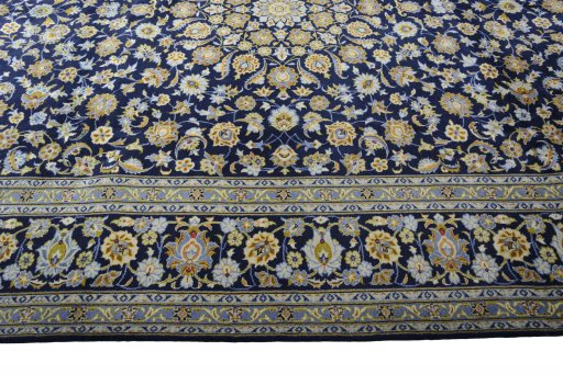 Corner detail of 2000s Kashan rug showing border pattern and Wool pile
