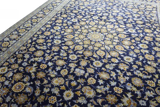 Backside of handmade 2000s Kashan rug showing knot structure and weave density