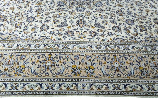 Corner detail of 2000s Kashan rug showing border pattern and Wool pile