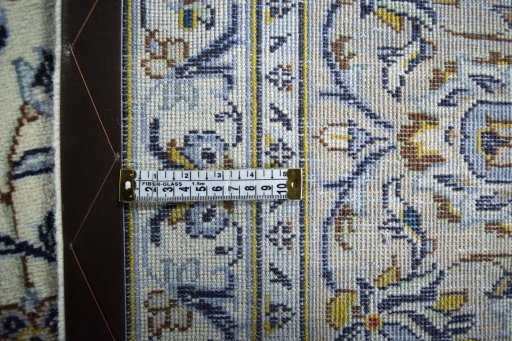 Backside of handmade 2000s Kashan rug showing knot structure and weave density