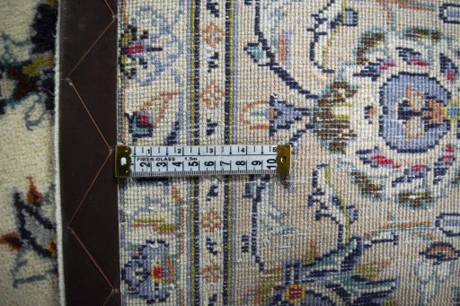Backside of handmade 2000s Kashan rug showing knot structure and weave density