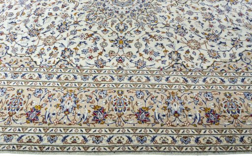 Corner detail of 2000s Kashan rug showing border pattern and Wool pile