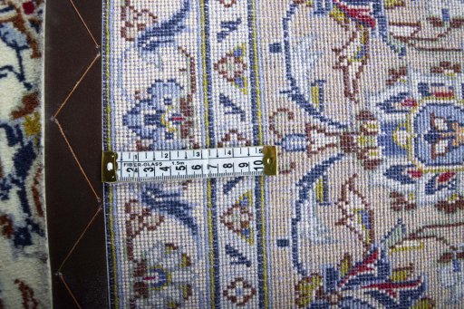 Backside of handmade 2000s Kashan rug showing knot structure and weave density