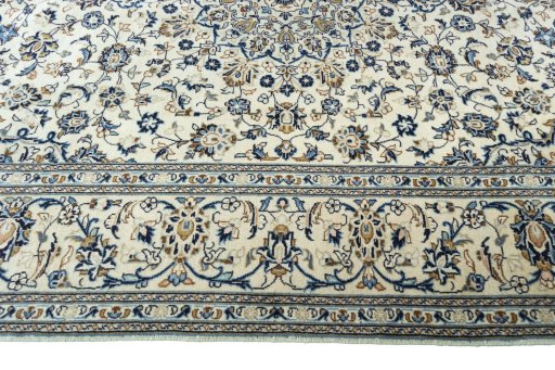 Corner detail of 2000s Kashan rug showing border pattern and Wool pile