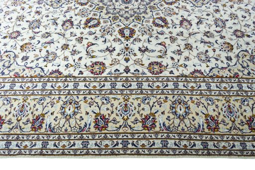 Corner detail of 2000s Kashan rug showing border pattern and Wool pile