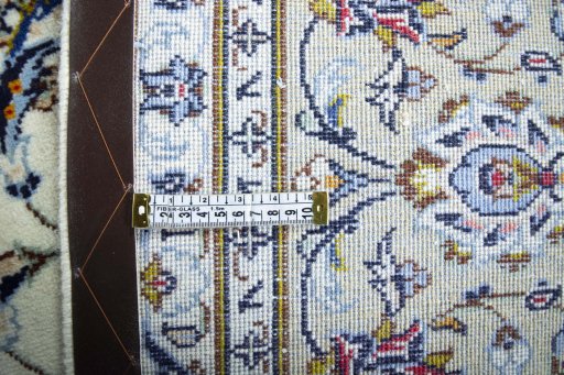 Backside of handmade 2000s Kashan rug showing knot structure and weave density