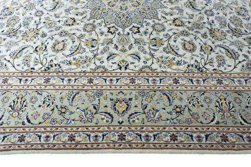 Corner detail of 2000s Kashan rug showing border pattern and Wool pile